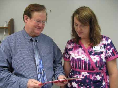 Dr. McBiles reviews a file with Kaylee Palmer, as they now offer Nuchal testing
