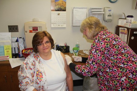 Sally Clemente, RN our Employee Health Infection Control Coordinator expertly delivers a flu shot to Nancy Abrams.