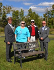 Littauer President and CEO Laurence Kelly, Gloversville Lions Club VP Linda Rhinehart, Gloversville Lions Club President David J. Miller and Littauer Foundation Executive Director Geoffrey Peck on the Littauer walking track with donation