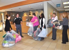  Ryan Baxter of Century Linens collects winter clothing donated by Littauer employees