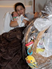 Alexis Ford of Gloversville with her new born son Kendrick John Lee are the recipients of the Friends of the Gloversville Public Library gift basket at Littauer’s Birthing Center during National Friends of Libraries Week in October.