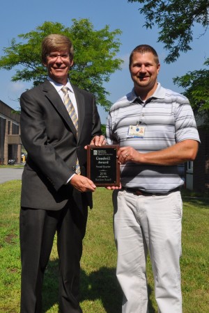 Littauer President and CEO, Laurence E. Kelly, left, presents MIS System Administrator Matthew Romrell with the 2016 second-quarter Goodwill Award