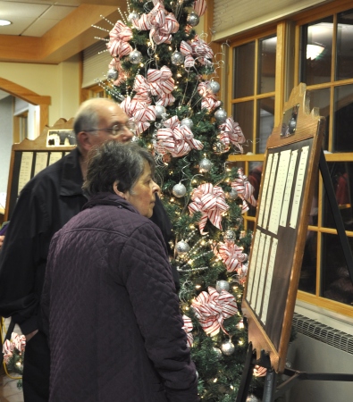 Charles and Anita Ashelman of Gloversville read the names of loved ones posted at the Nathan Littauer Hospital & Nursing Home Auxiliary annual Tree of Lights program