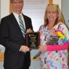 NLH President and CEO Laurence E. Kelly presents medical receptionist Barbara Hill with the NLH 2015 fourth-quarter Goodwill Award