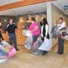 Ryan Baxter of Century Linens collects winter clothing donated by Littauer employees