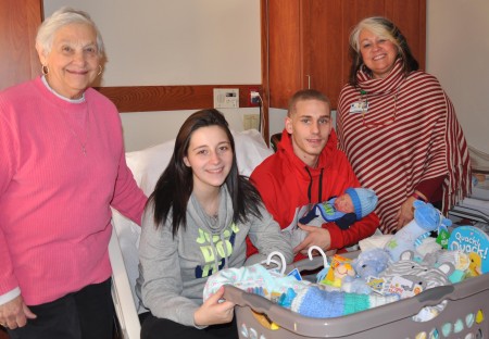 Littauer’s first baby of 2018, Ryder Xavier Henderson, seated with his parents Ashley Boles and Aaron Henderson of Gloversville. Standing is NLH&H Auxiliary President Norma Cozzolino, left and NLH Director of Volunteer Services Susan McNeil